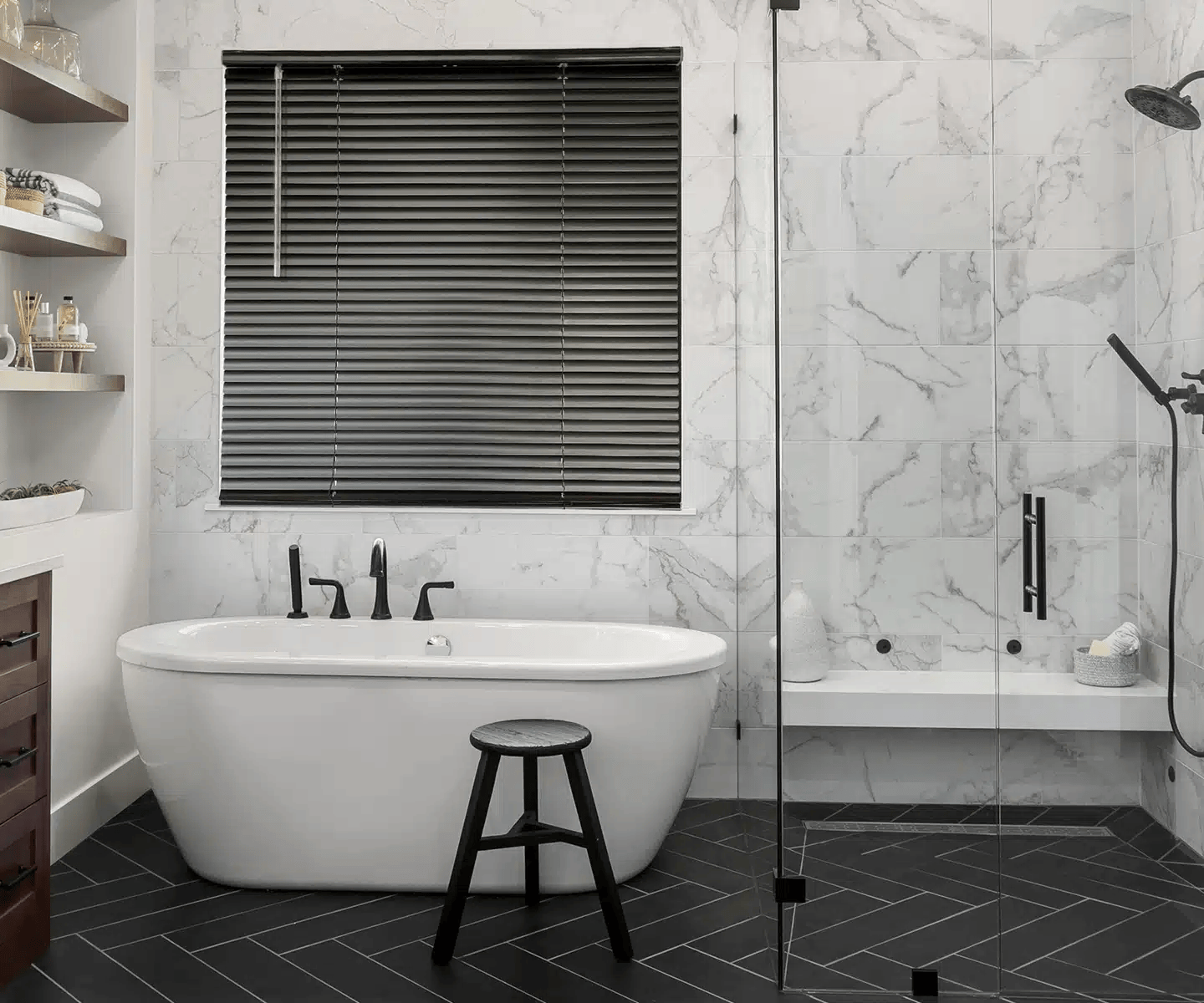 Modern white bathroom with freestanding tub, glass shower, and black blinds Modern white bathroom with freestanding tub, glass shower, and black blinds