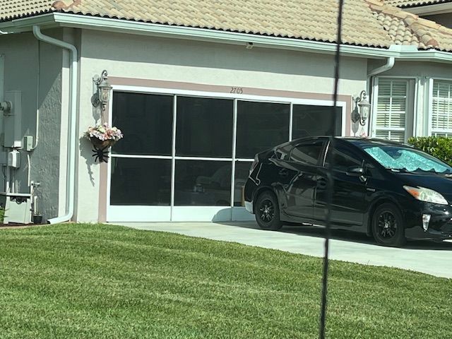 A person is applying caulk to a window frame.