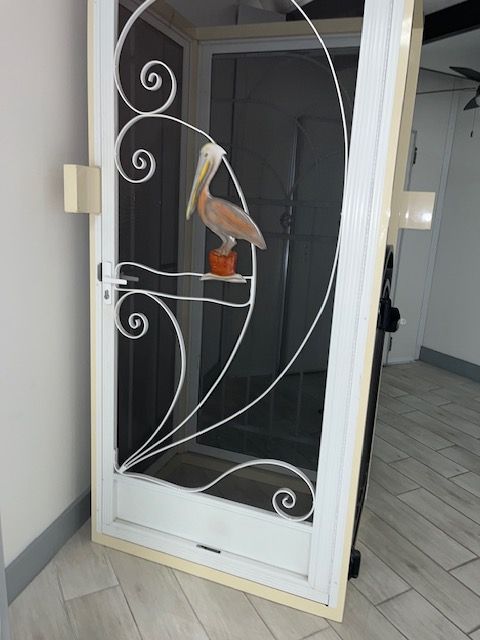 A screened in porch with a view of a body of water.