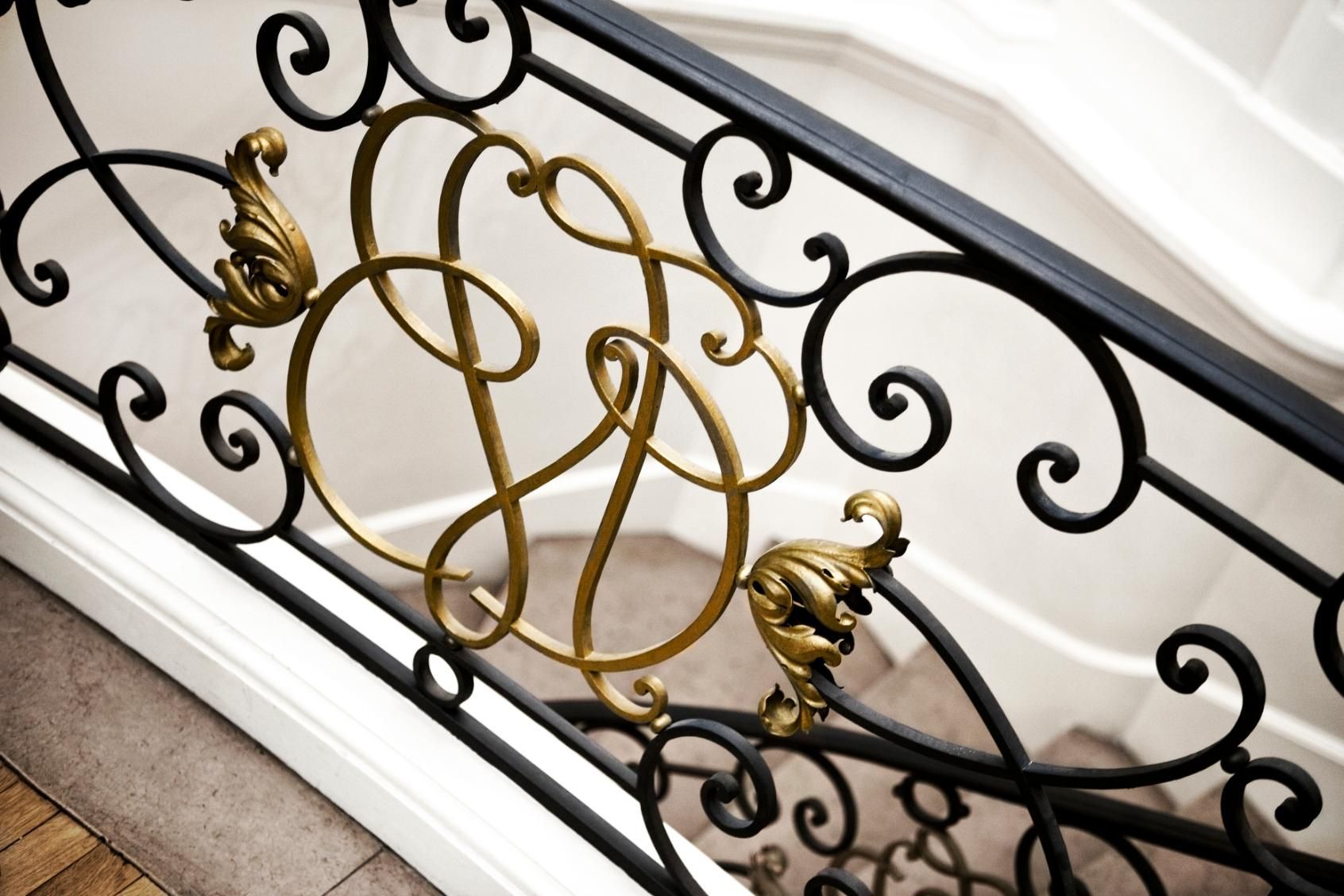A close up of a wrought iron railing on a staircase.