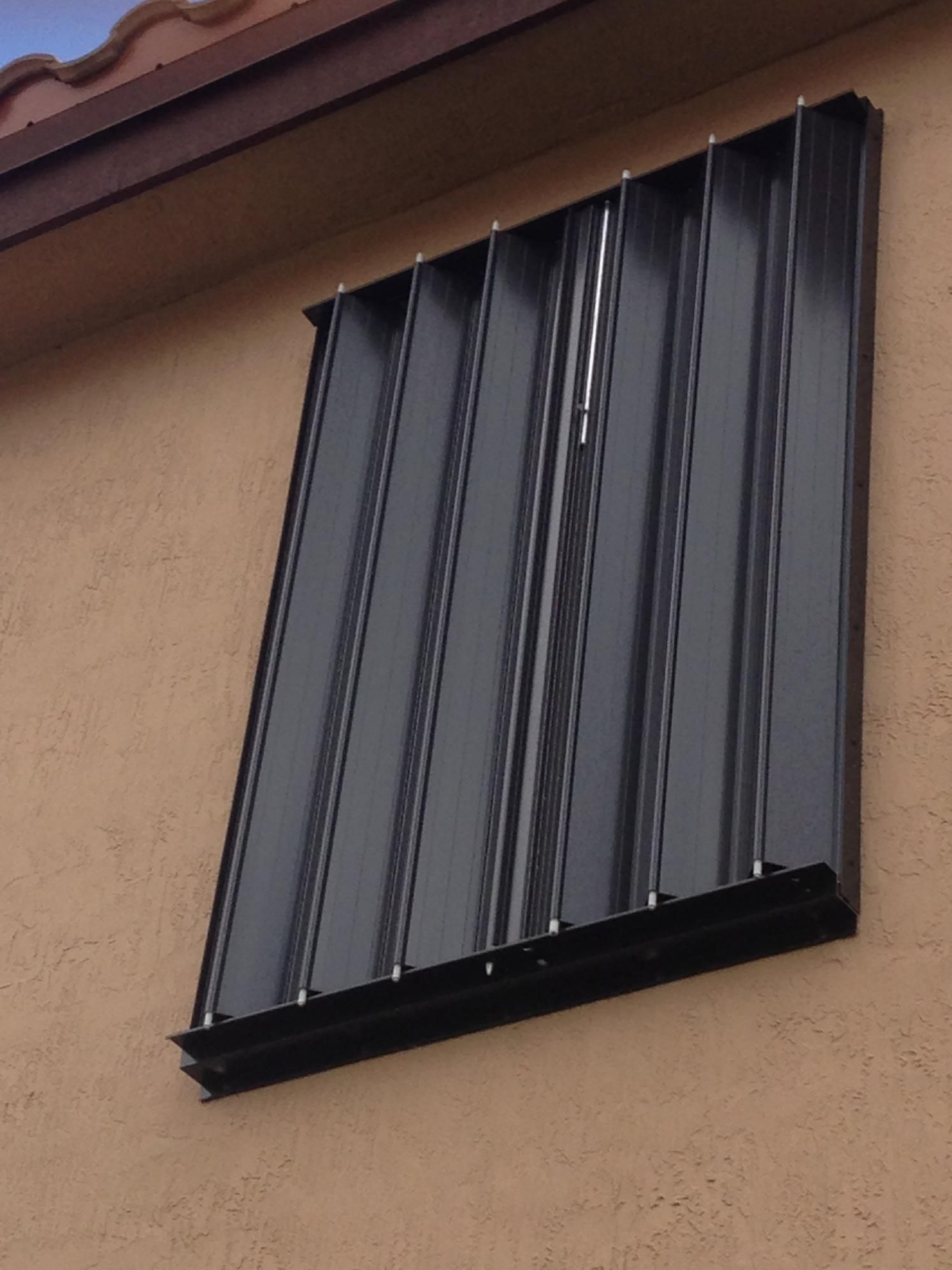 A window with a black shutter on it.
