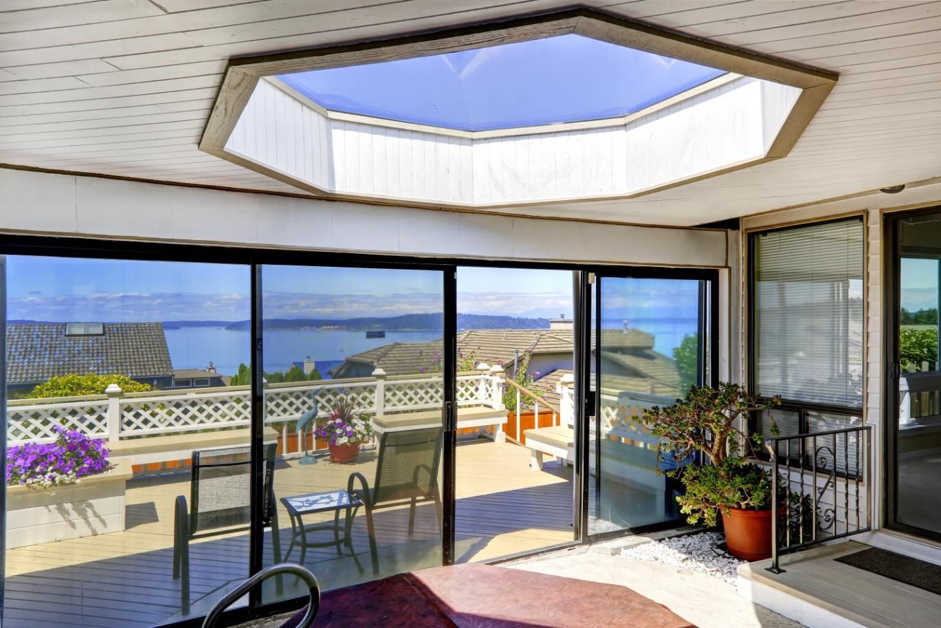 A sun room with sliding glass doors and a skylight.