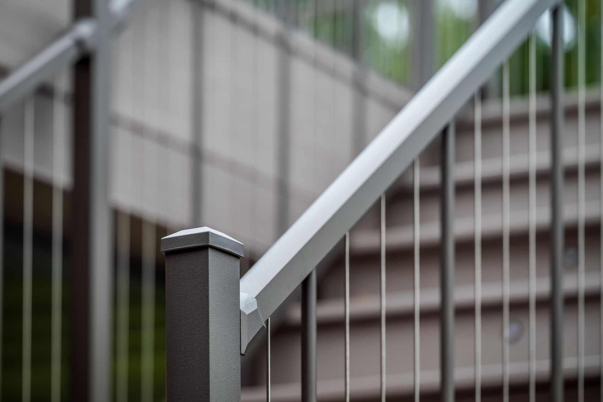 A close up of a metal railing on a set of stairs.