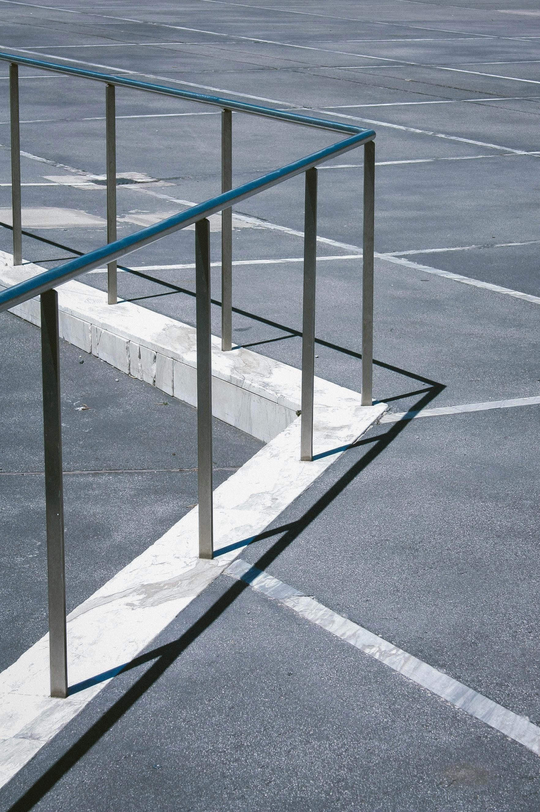 A staircase with a wrought iron railing and a stone wall.