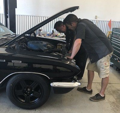 Car Repair — Mechanic Checking On The Wheels In Coeur d'Alene, ID