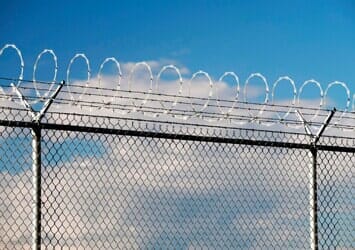 Security fence with barbed and razor wire — Security fencing installation in Pasadena, TX