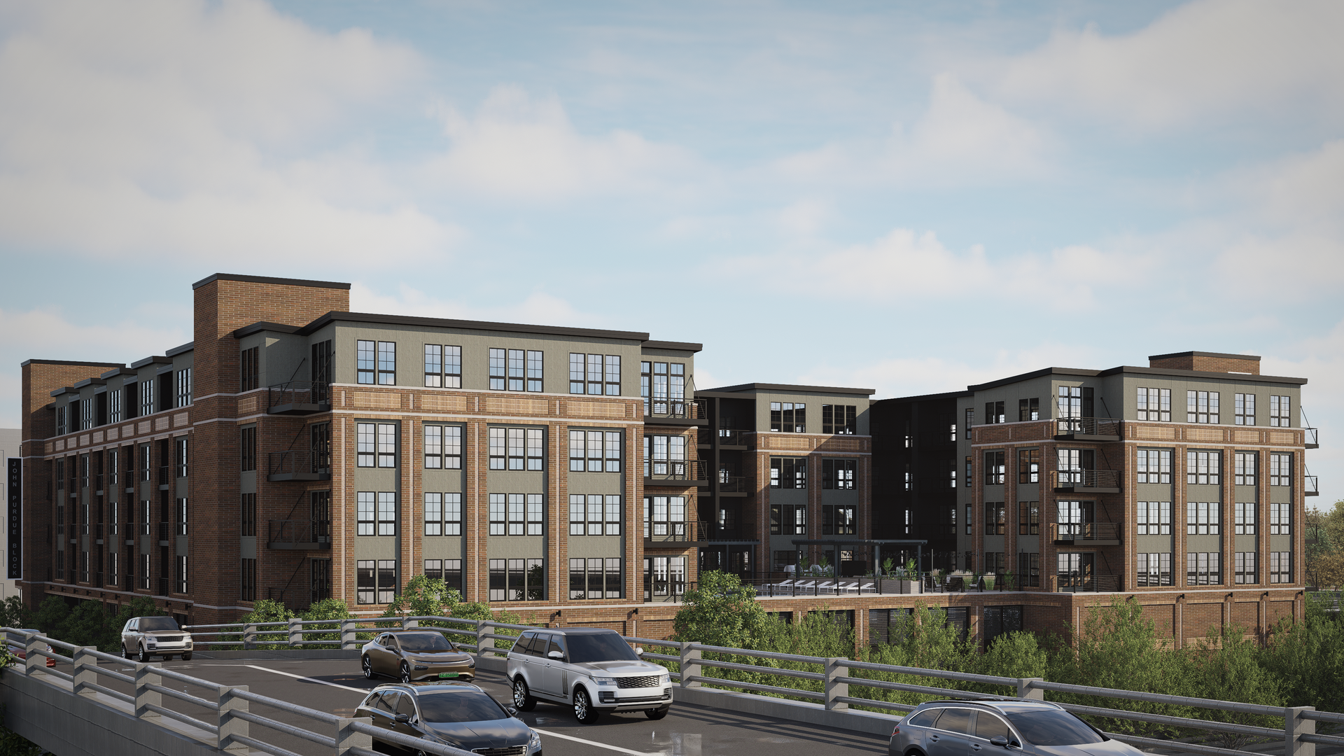 Apartment building with brick exterior and numerous windows, viewed from a bridge with cars.