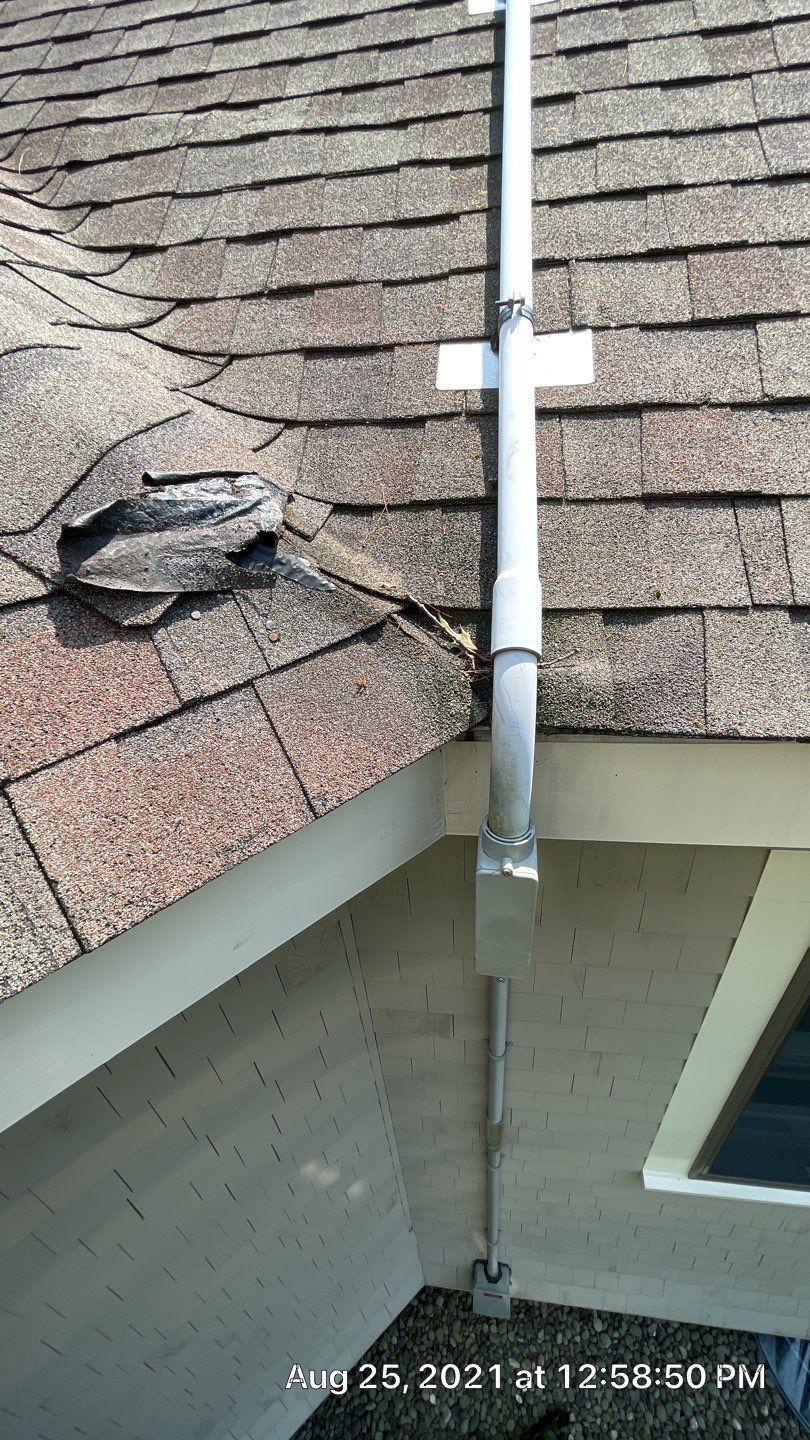 A close up of a gutter on a roof of a house.