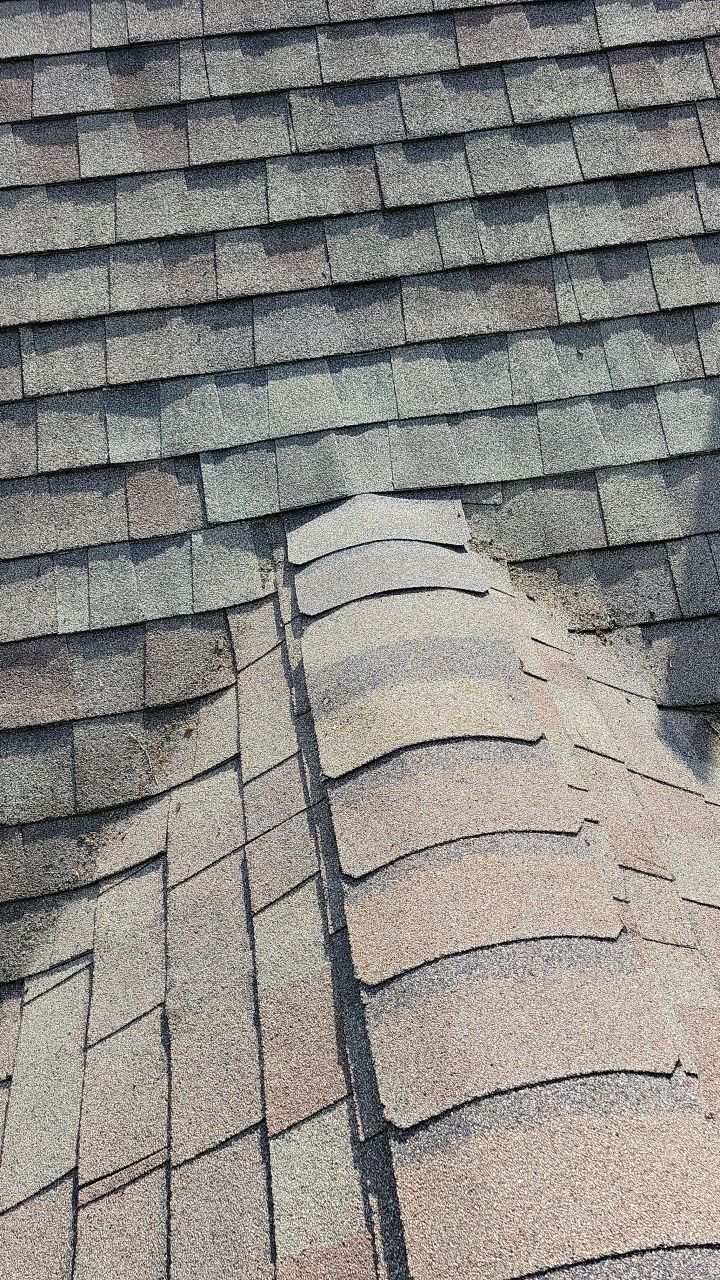 A close up of a roof with shingles that are missing.