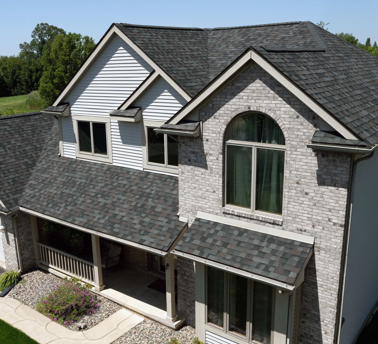 An aerial view of a house with a black roof