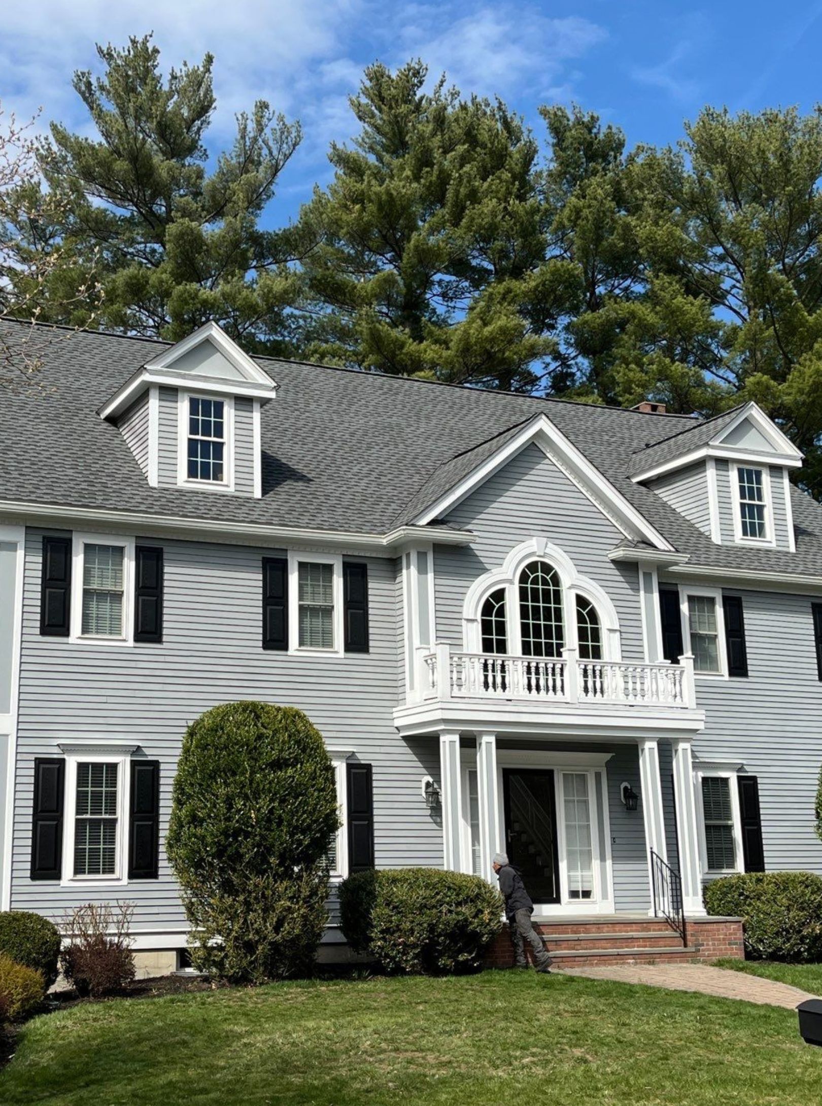 A white house with a ladder on the side of it.
