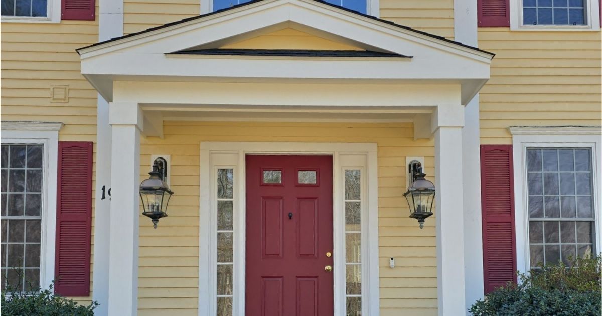 white front porch on a yellow house