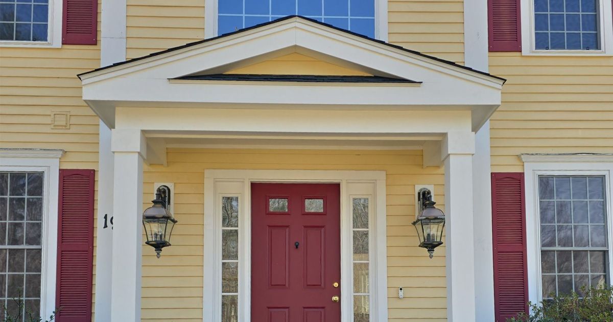 white front porch on a yellow house