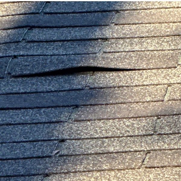 roof with lifting shingles