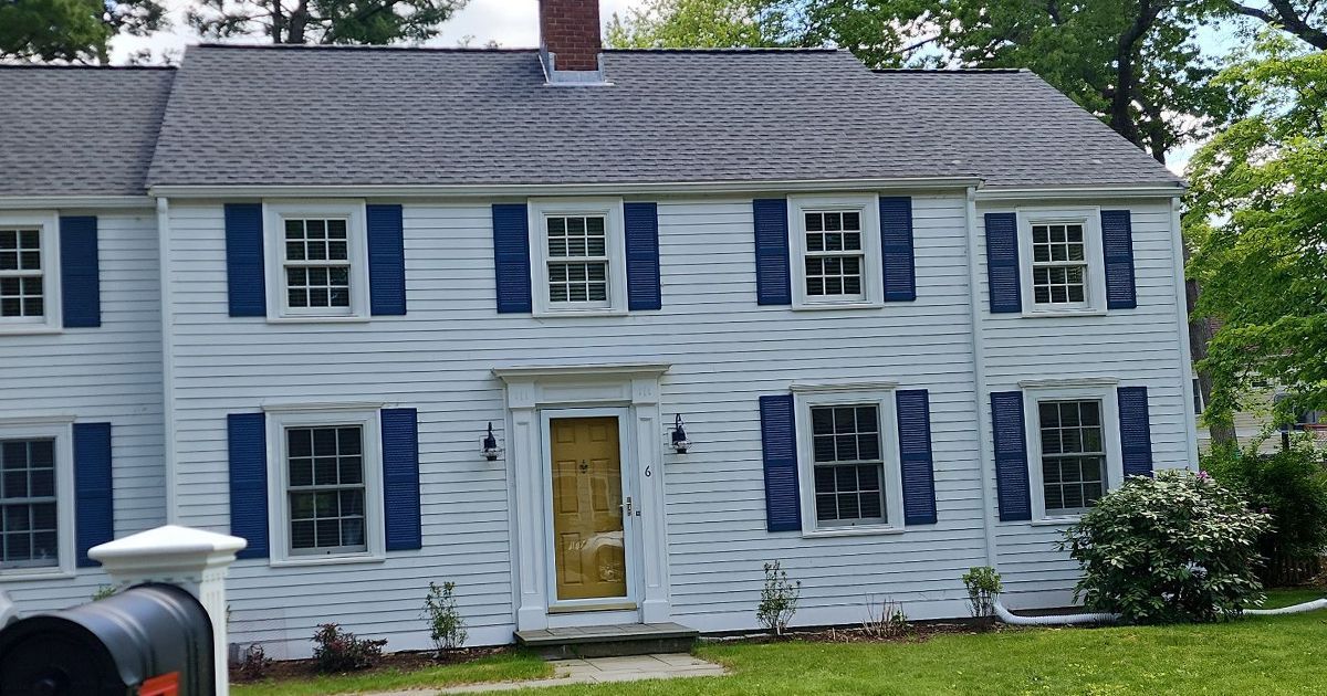 A large white house with a gray roof Wellesley MA