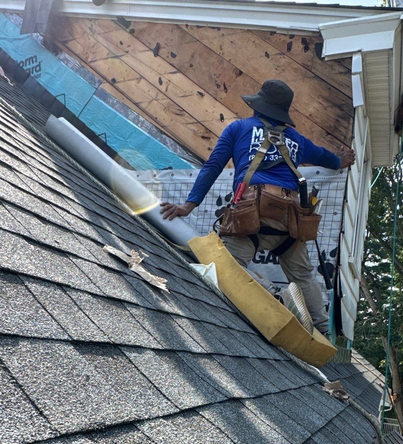 Installing flashing on a roof gable.