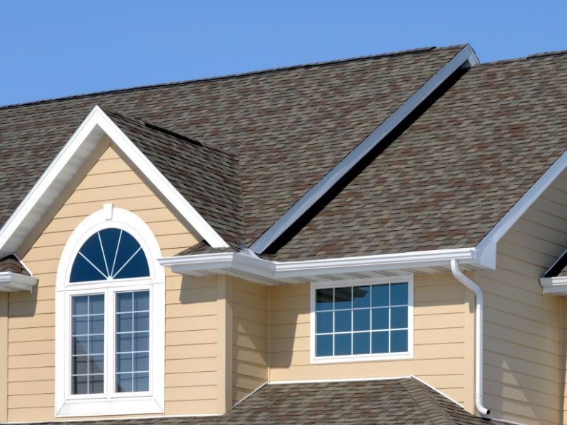 A house with a brown roof and white trim