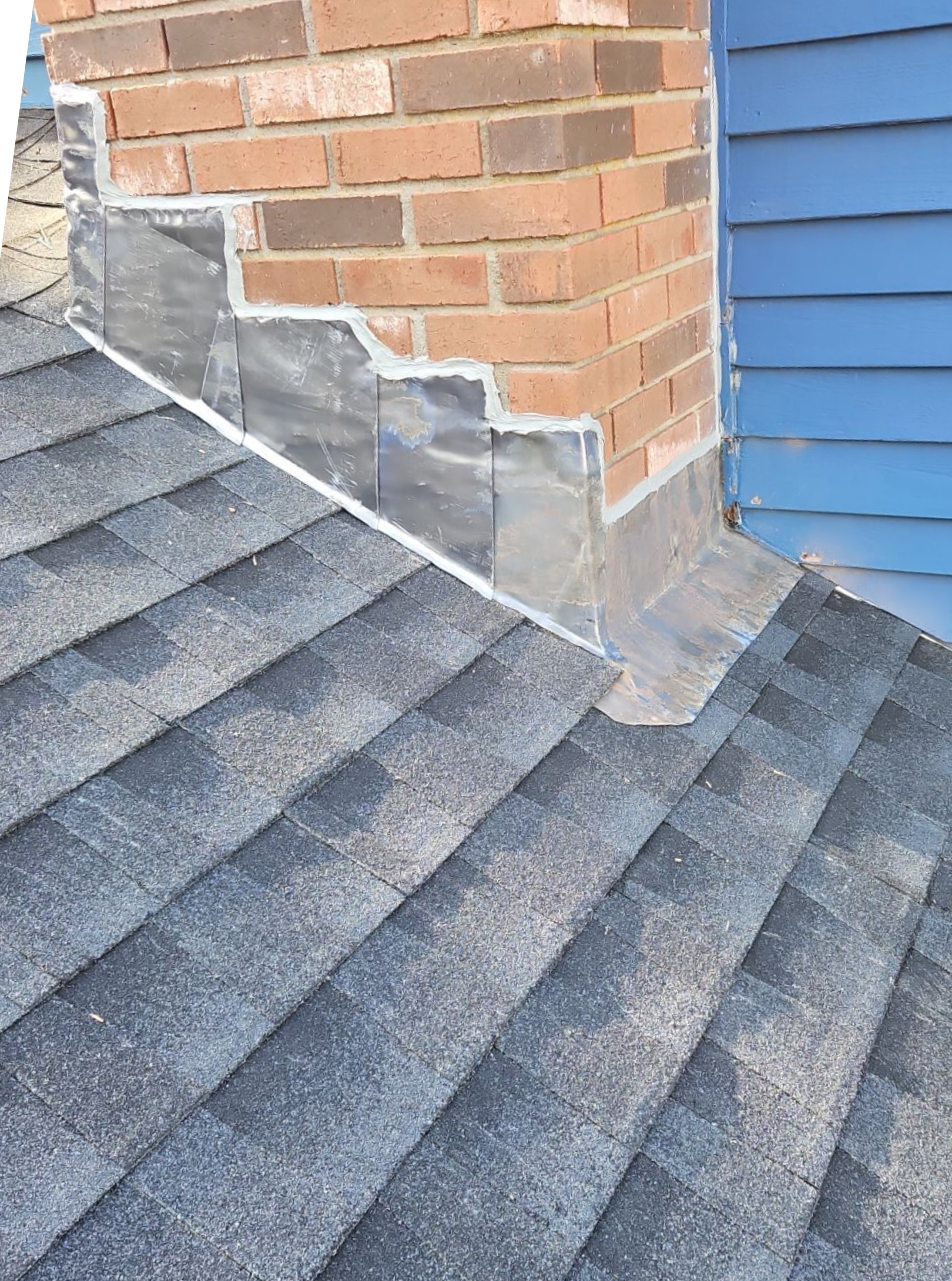 new shingles and chimney flashing