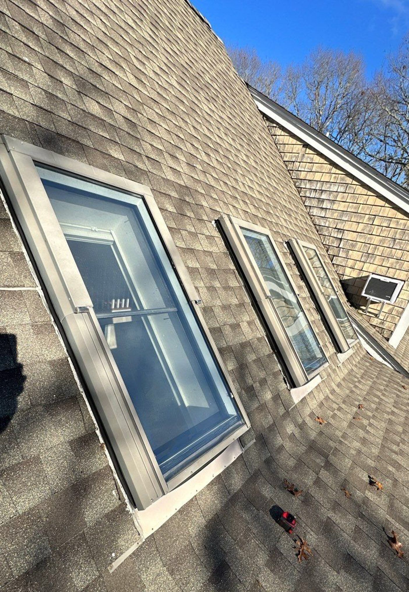 A row of skylights on the roof of a house.