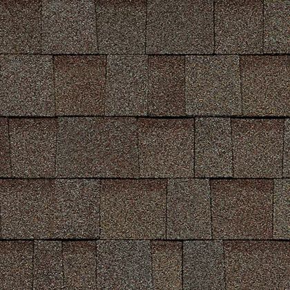A close up of a roof with brown shingles.
