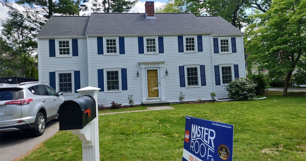 A large white house with a gray roof Wellesley MA