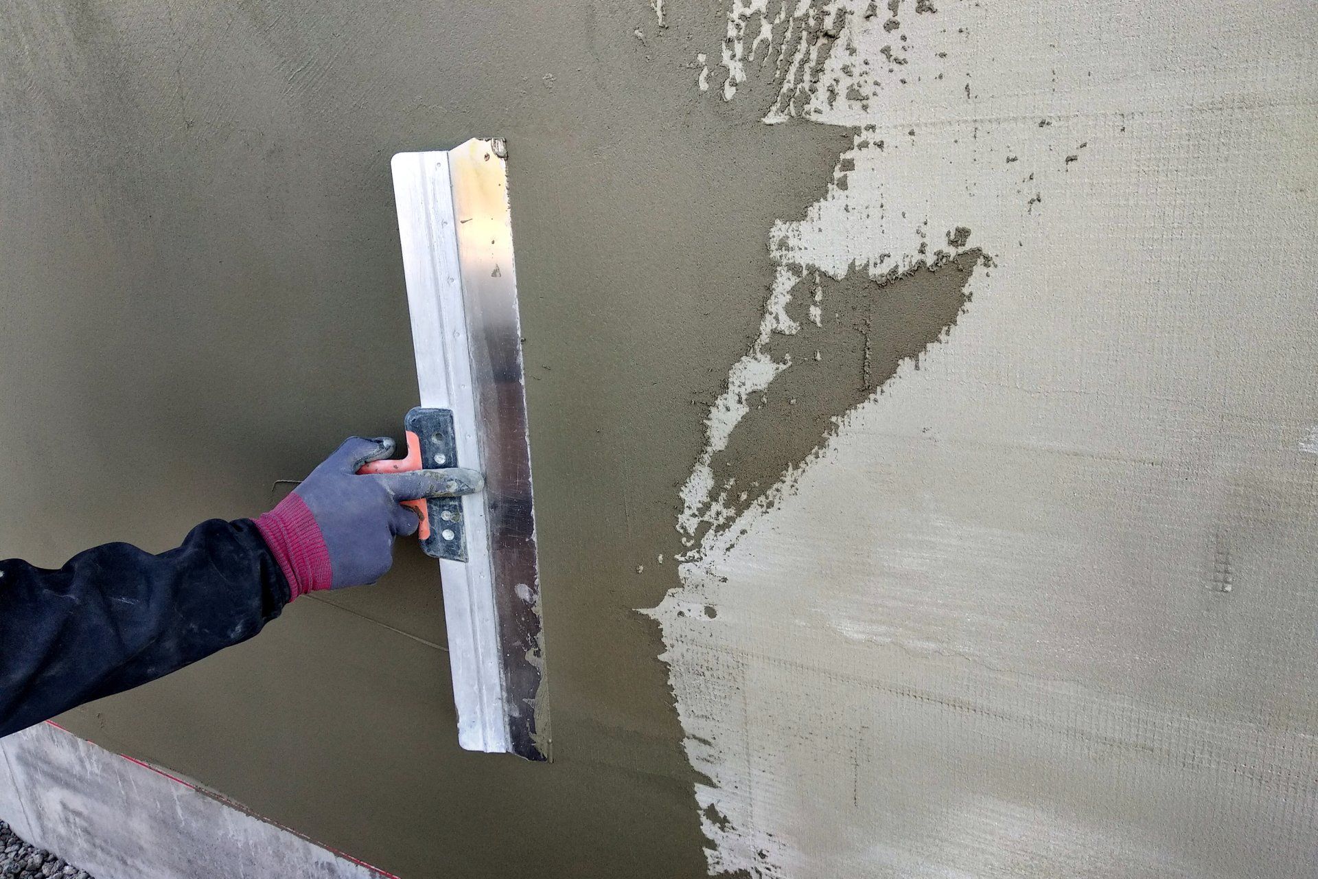man fixing cracks in the stucco of a home in mesa