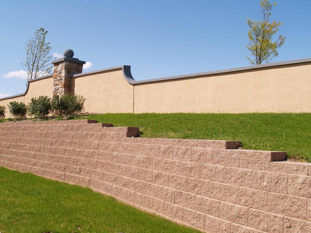 a perimeter wall that just got a new application of stucco applied to it in mesa