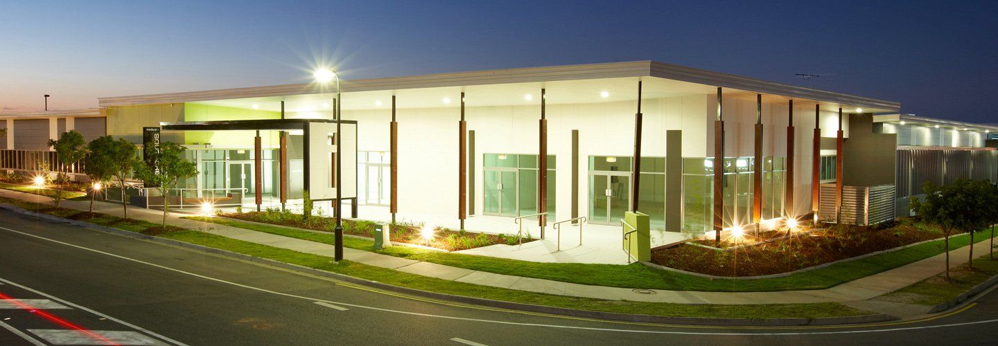 A large building with a lot of windows is lit up at night.