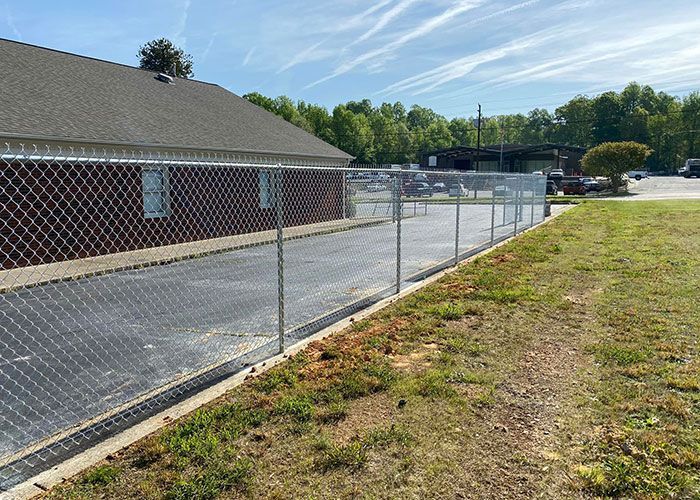 Chained Fence On An Empty Lot - Thomasville, NC - SP Custom Fencing & Custom Buildings