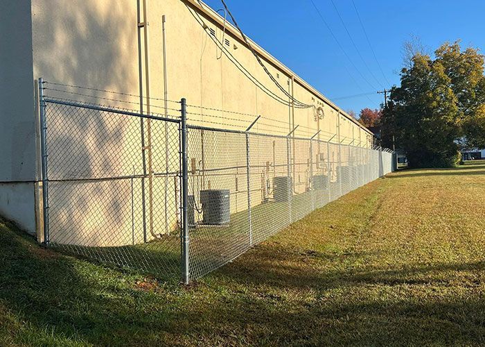 Side Of The Building Barbed Fence - Thomasville, NC - SP Custom Fencing & Custom Buildings