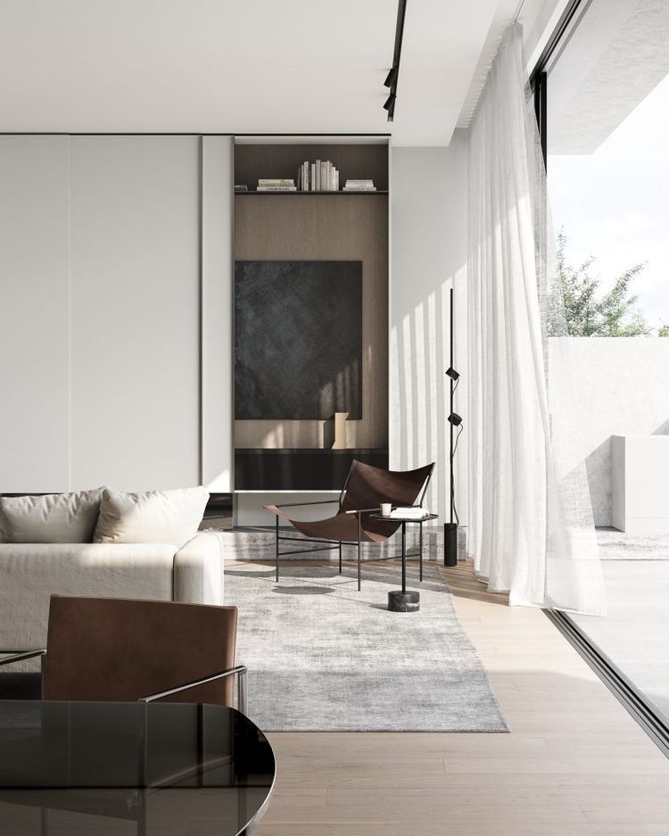 Un living cu o canapea, scaun, masă și uși glisante din sticlă.