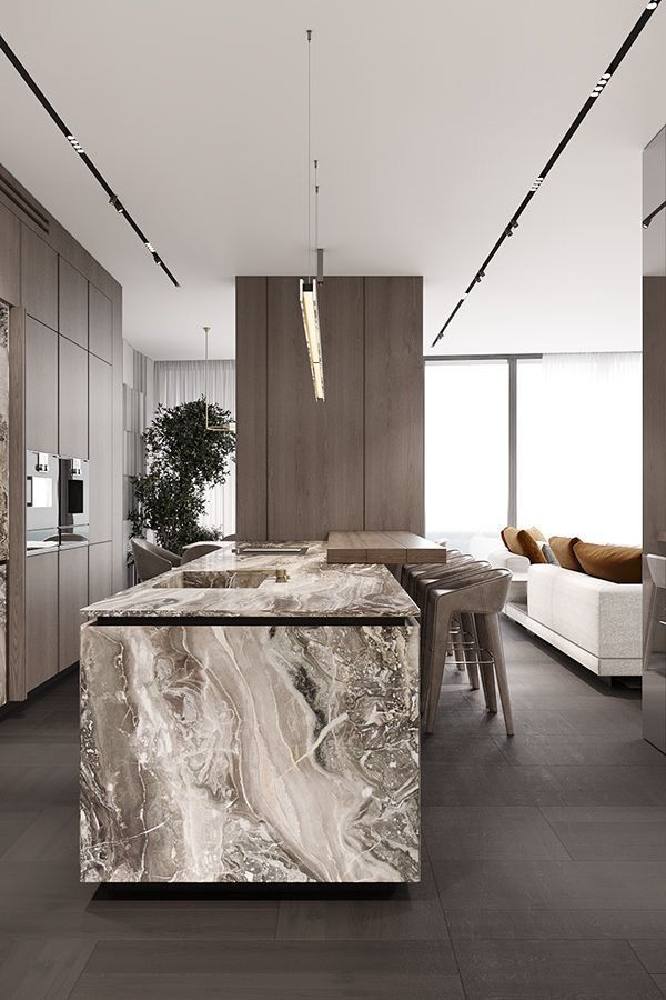 O bucătărie cu o insulă mare în mijlocul camerei.