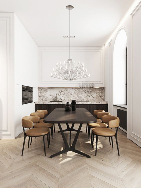 O sufragerie cu o masă și scaune și un candelabru atârnat de tavan.
