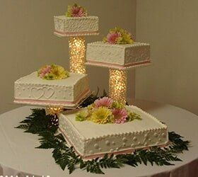 Four tier wedding cake on cylinders —  Wedding cakes in Des Moines, IA