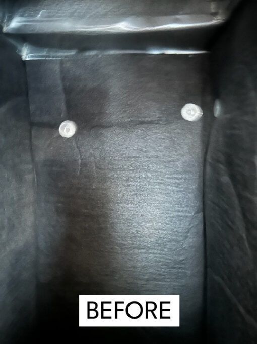 Interior of a dark gray box with two white circular objects, labeled