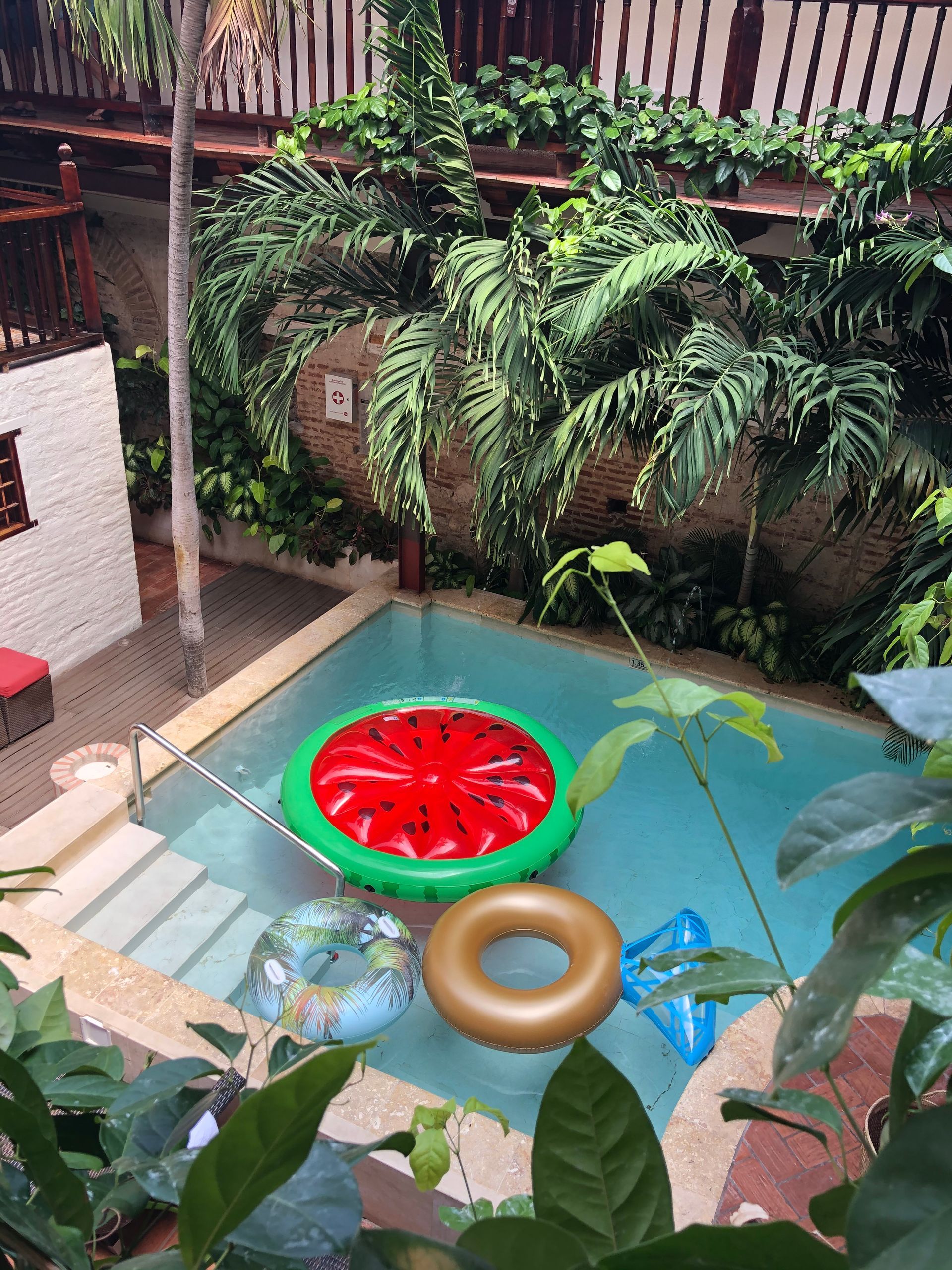 A swimming pool with a watermelon float in it