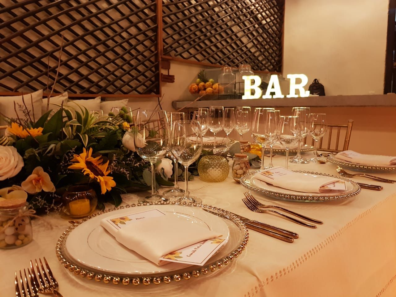 Formal table setting with flowers, glasses, and plates. 