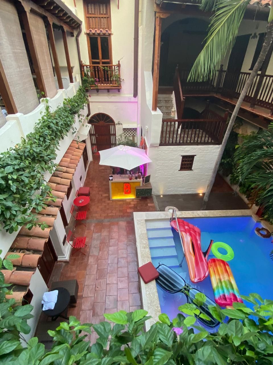 An aerial view of a swimming pool in a courtyard.