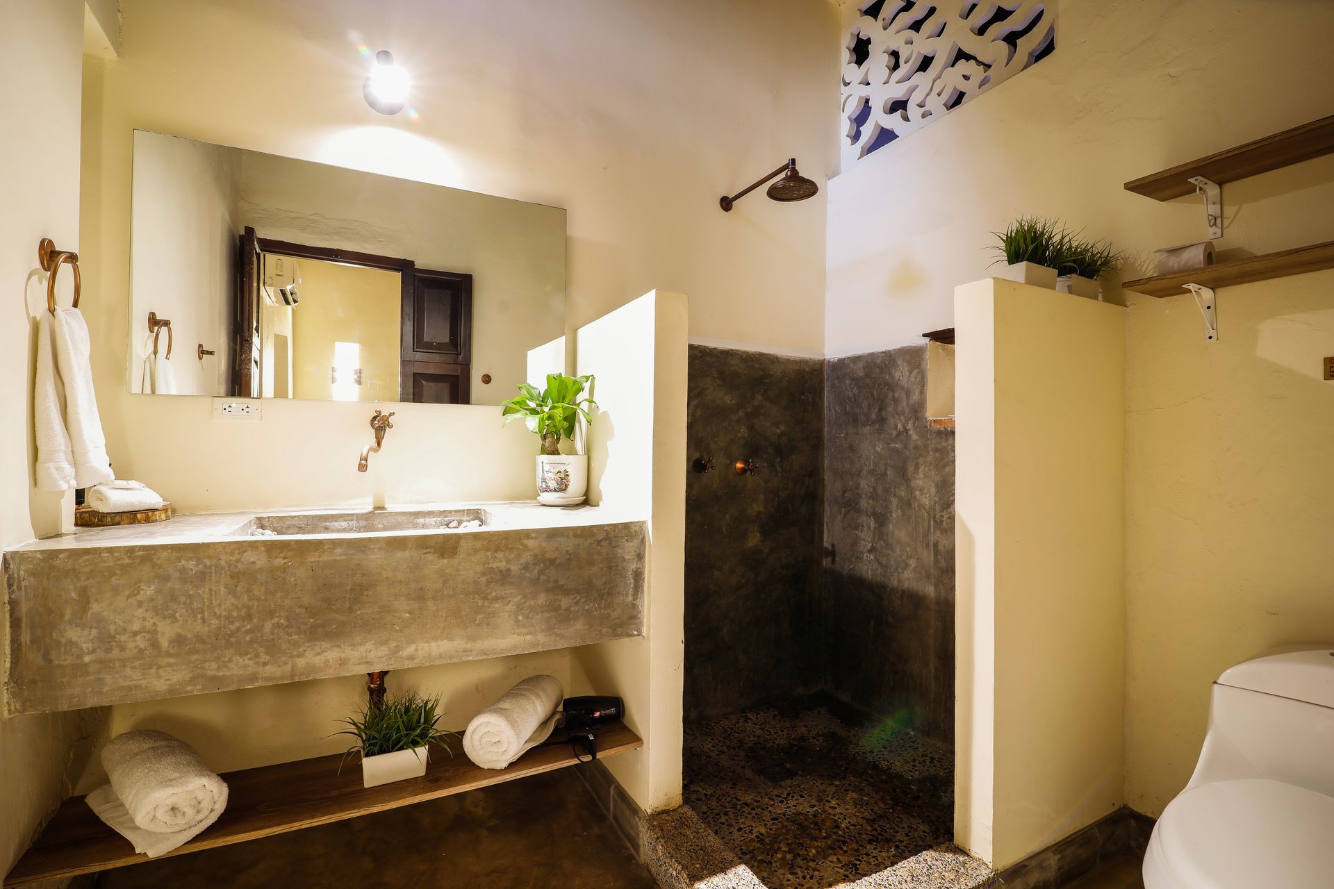 A bathroom with a sink , toilet and shower.