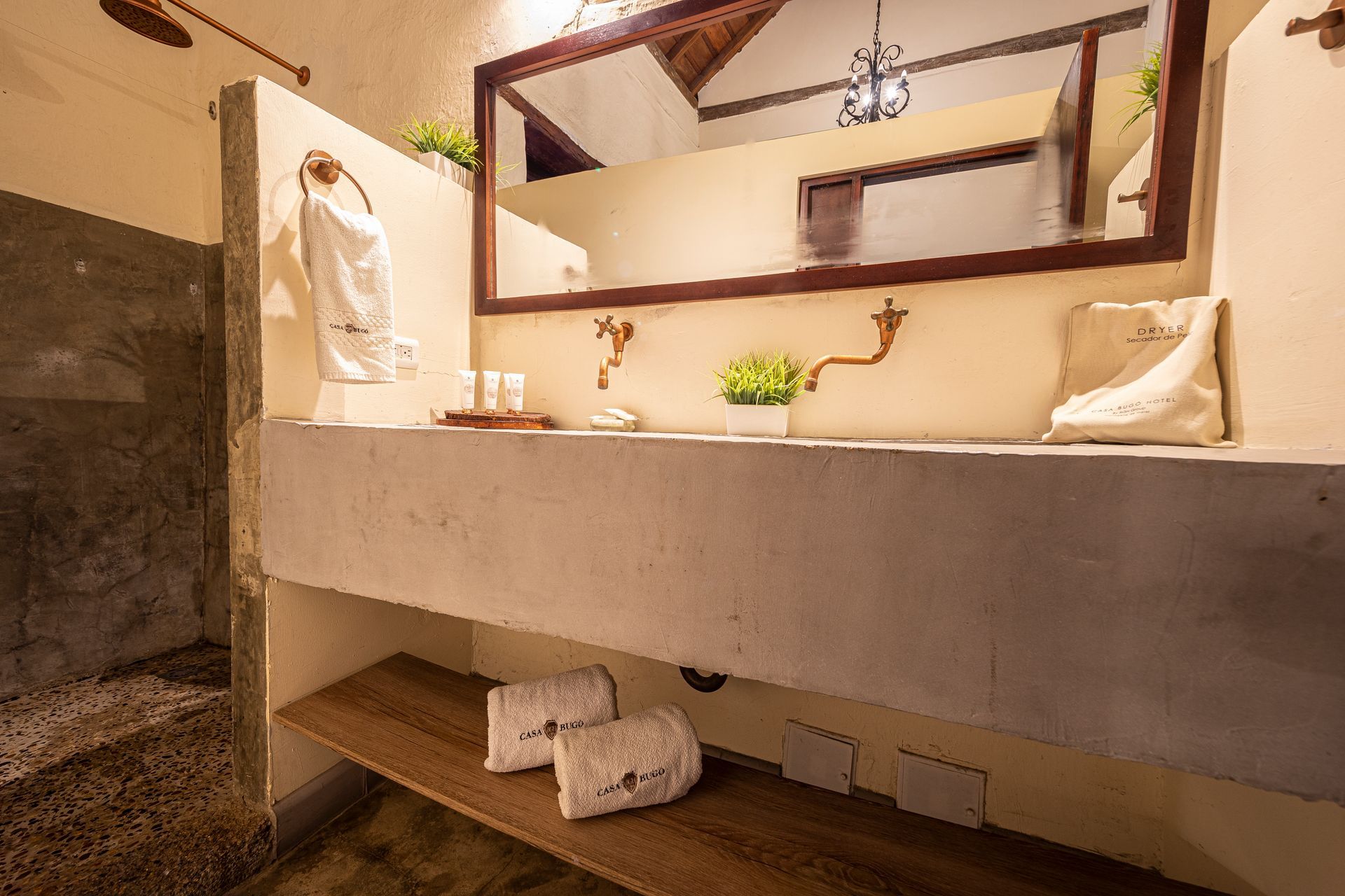 A bathroom with two sinks and a mirror.