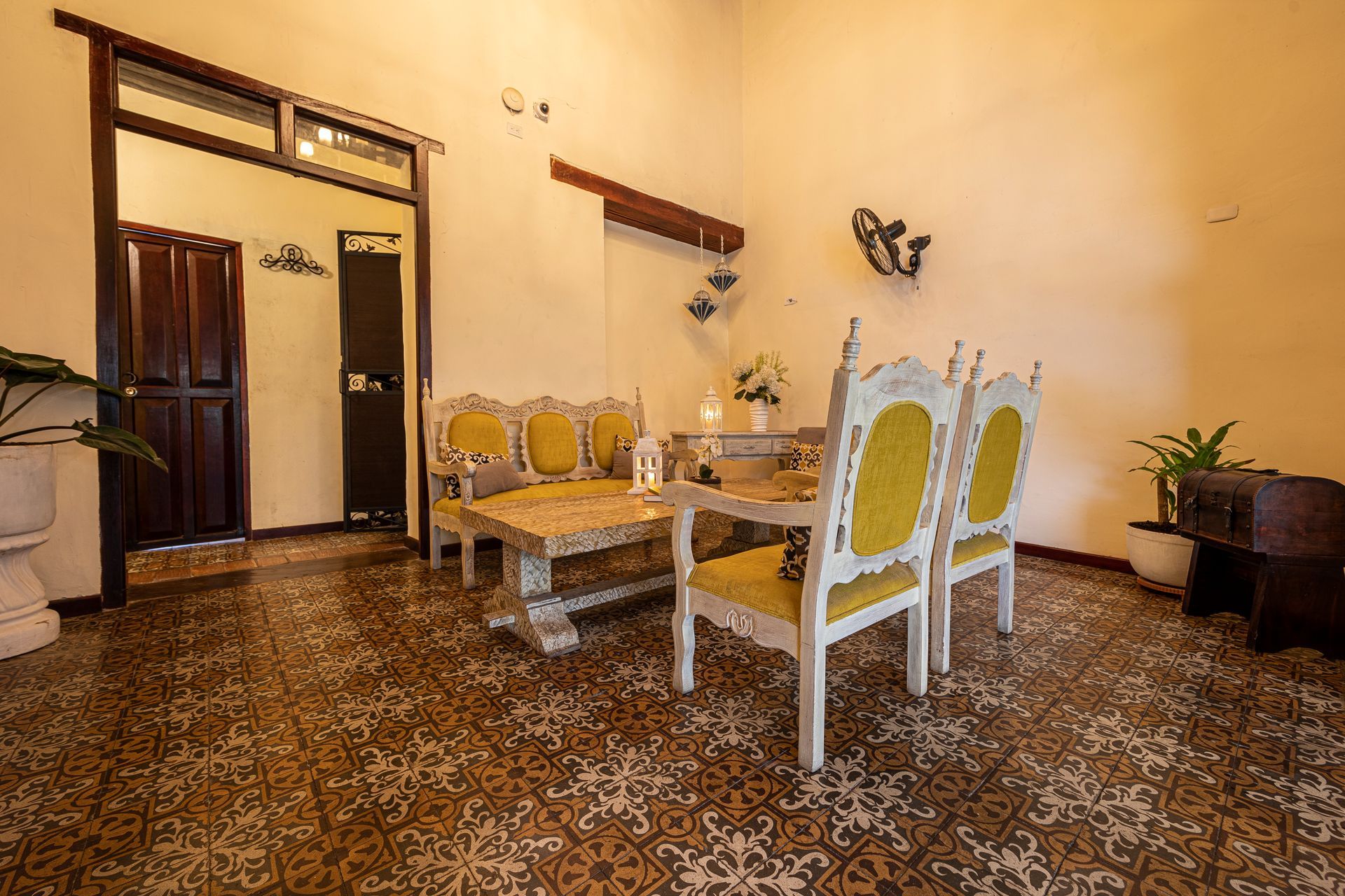 A living room with a table , chairs , and a couch.