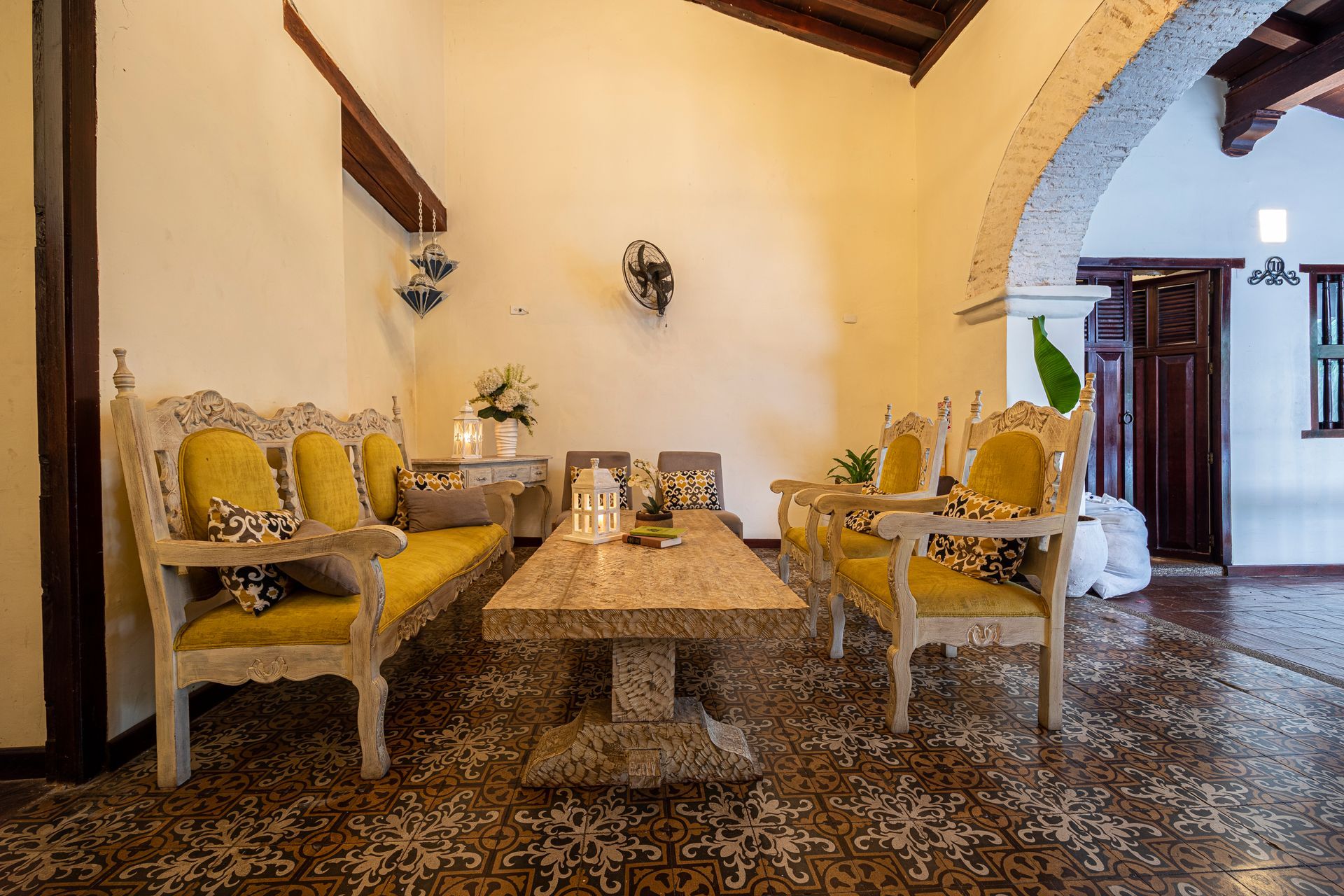 A living room with a couch , chairs , and a table.