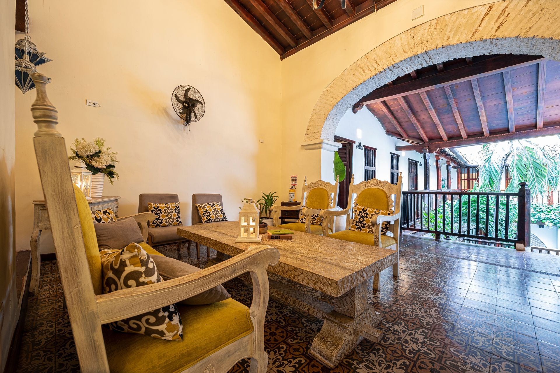 A living room with a table and chairs and a balcony.