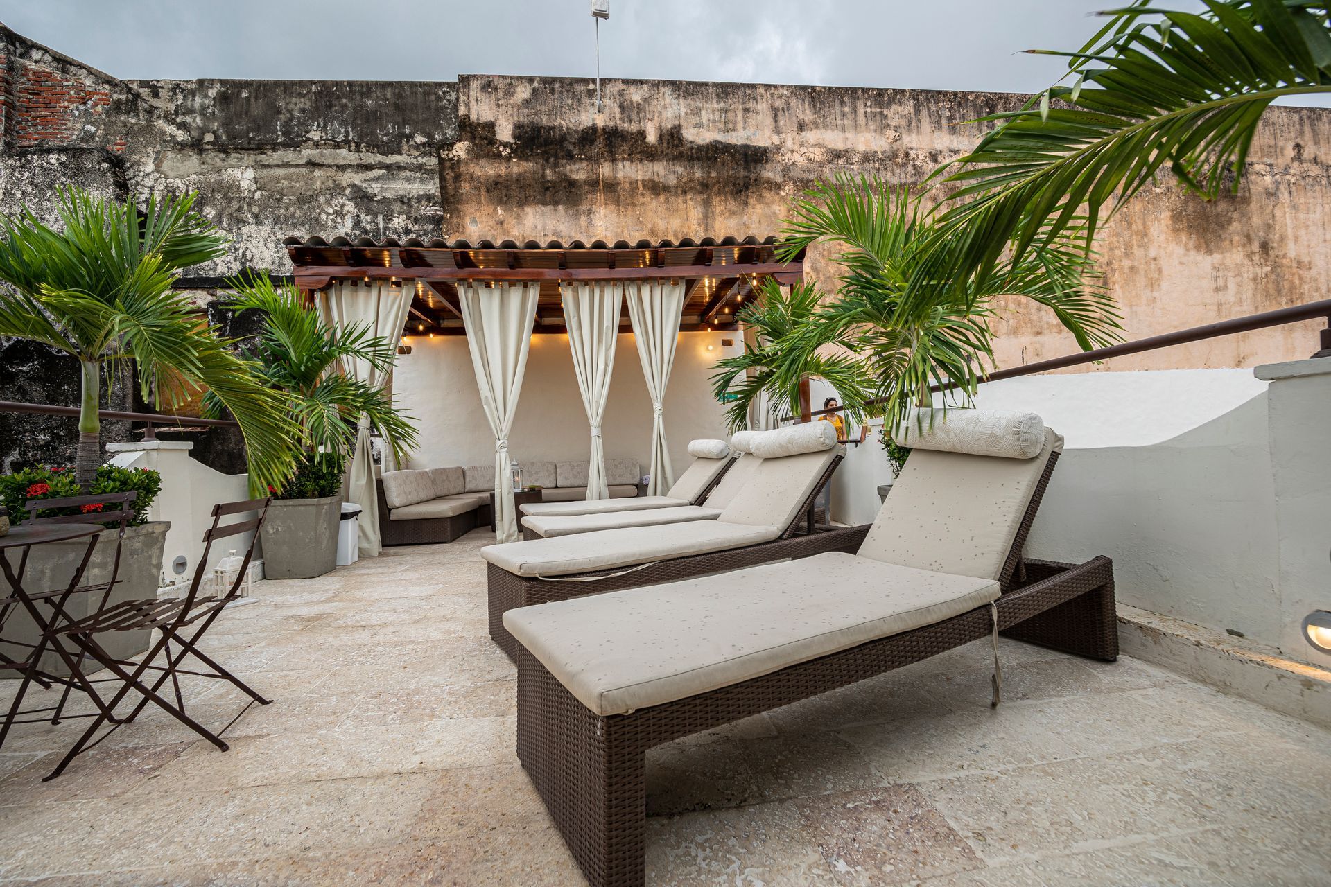 Two lounge chairs are sitting on a patio next to a table.