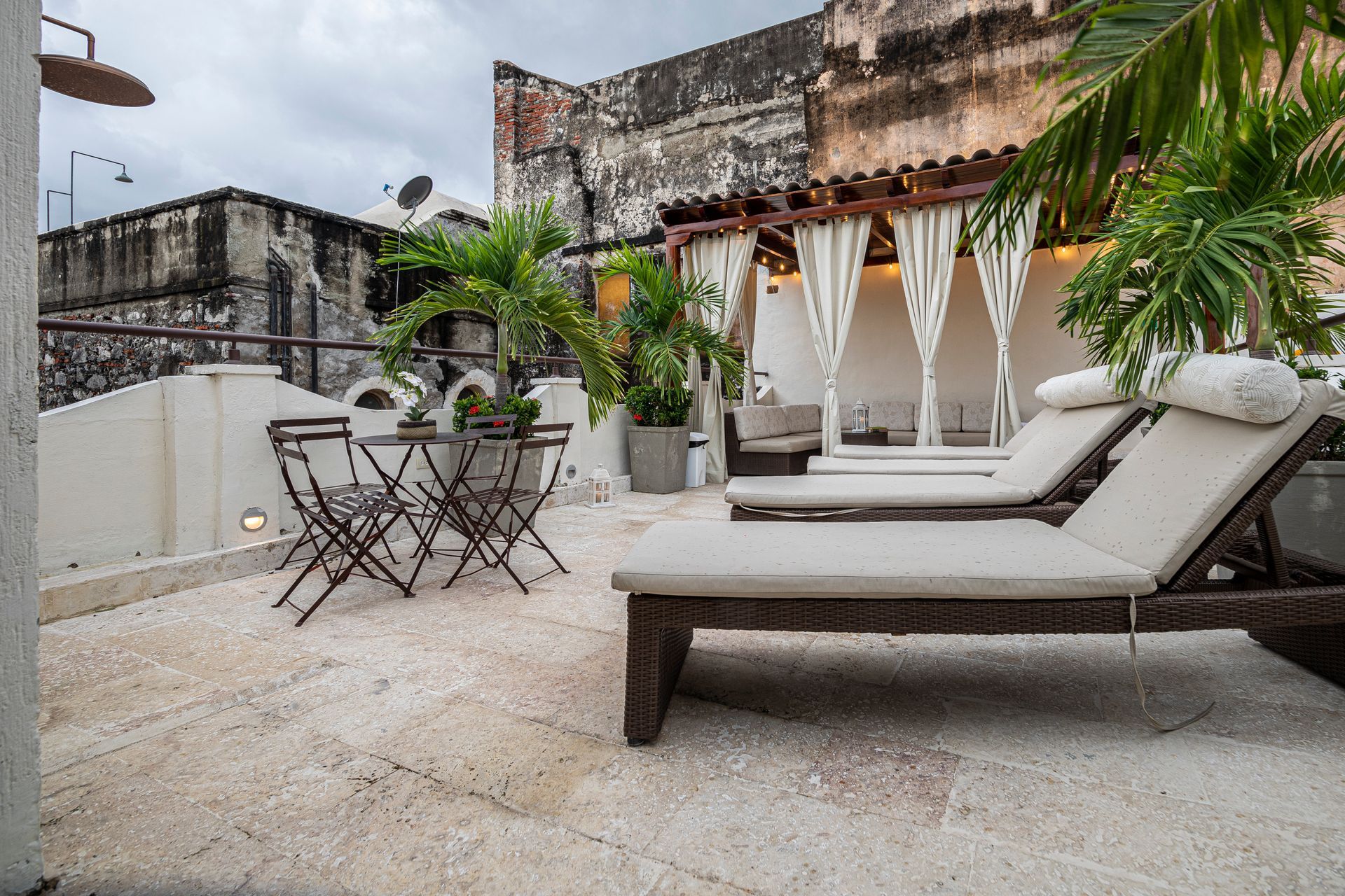 There are a lot of chairs and tables on the patio.