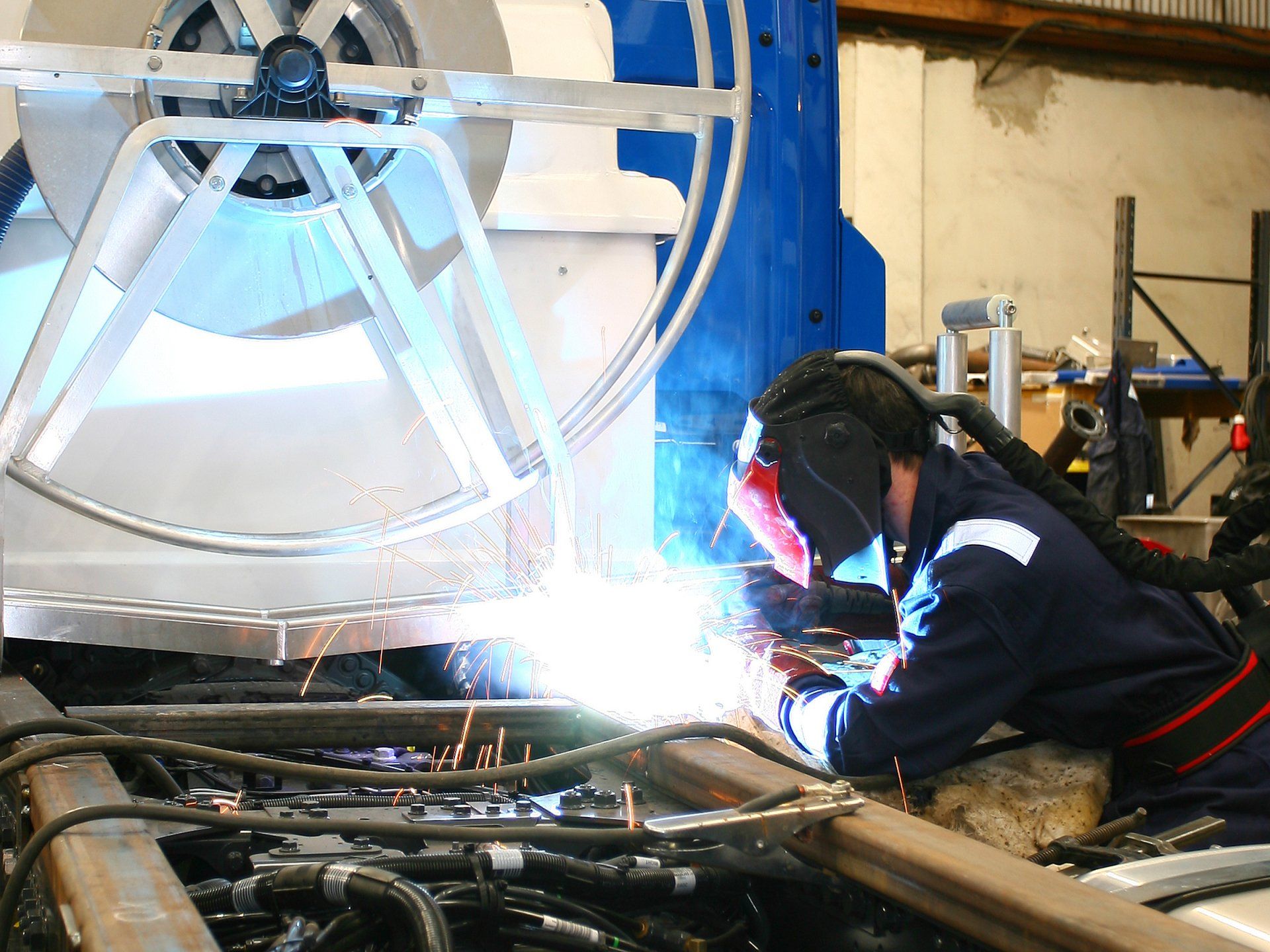 A welder welding two pieces of metal