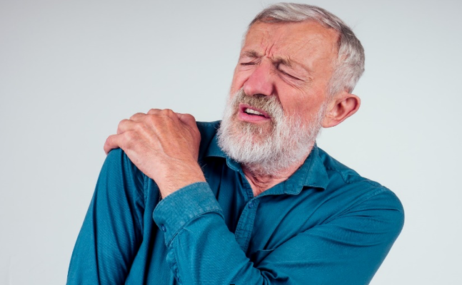 Man holding his shoulder due to some chronic pain condition