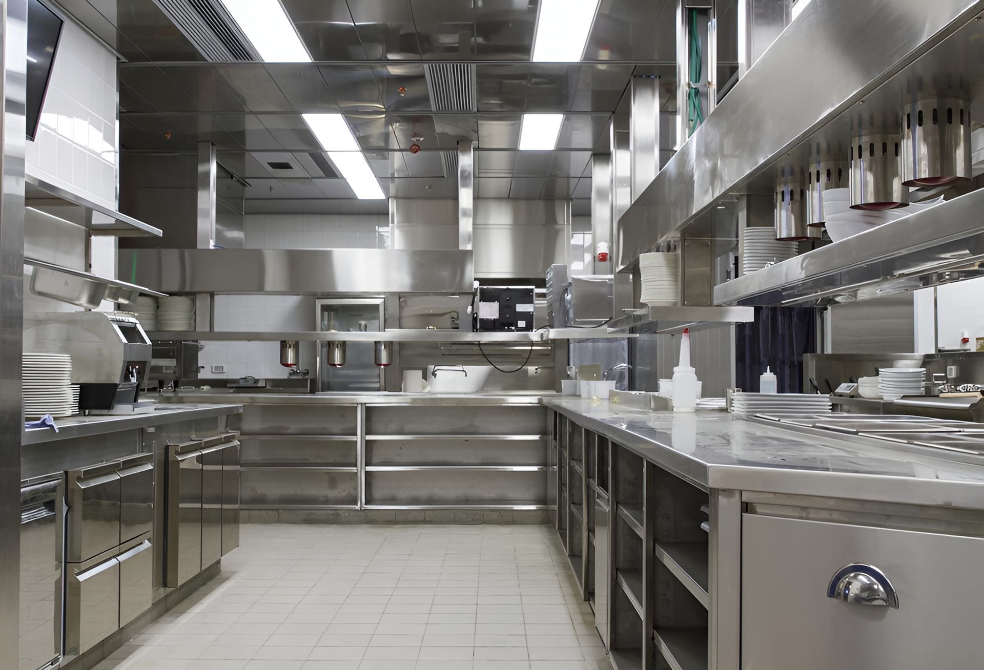 A commercial kitchen with a lot of stainless steel appliances