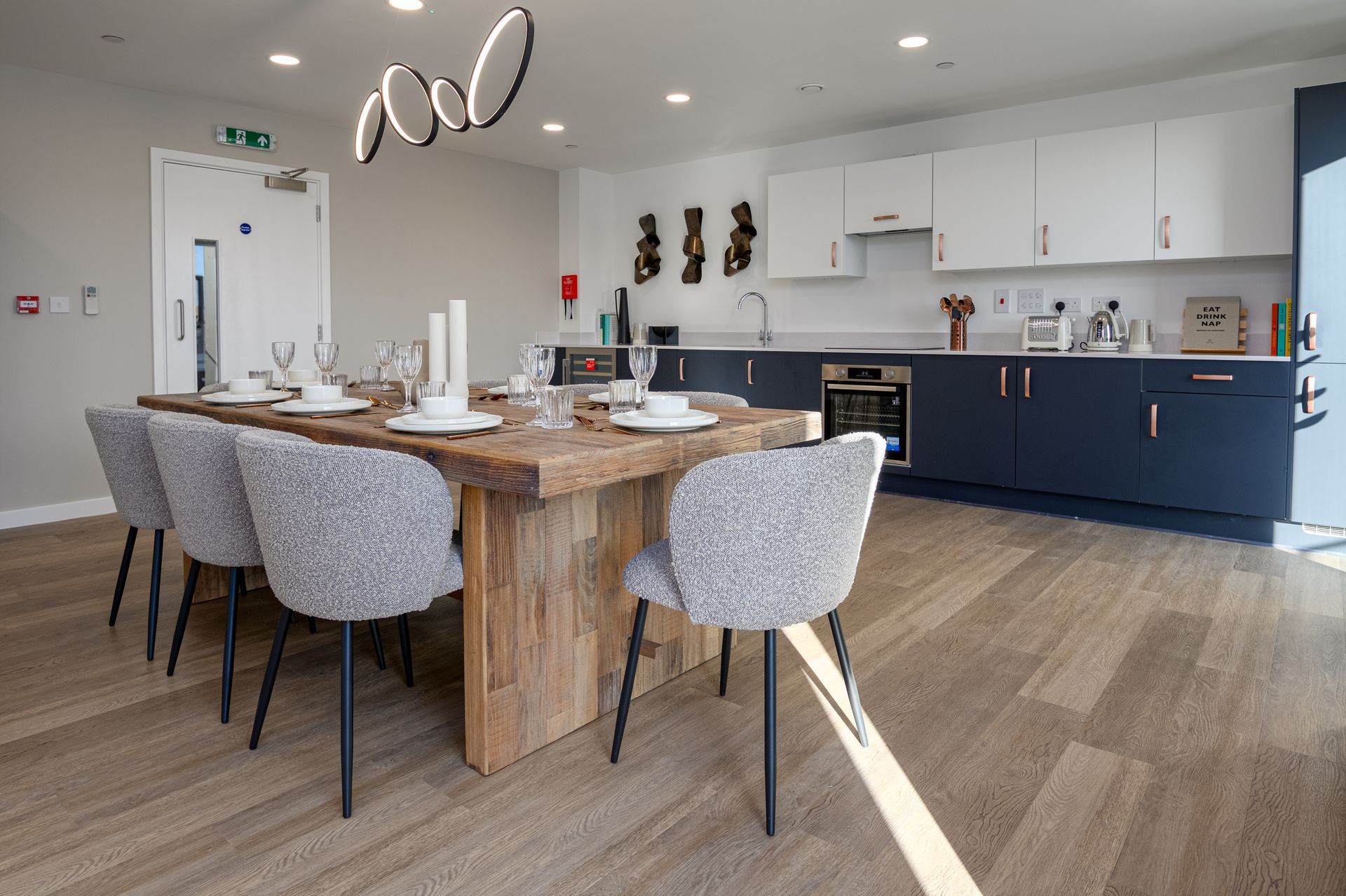 A kitchen with a large wooden table and chairs at Walton Court.