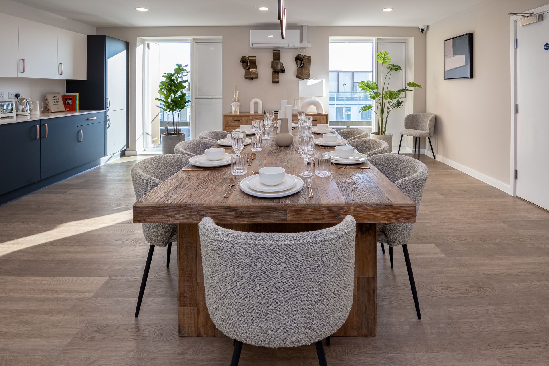 A dining room with a long wooden table and chairs at Walton Court.